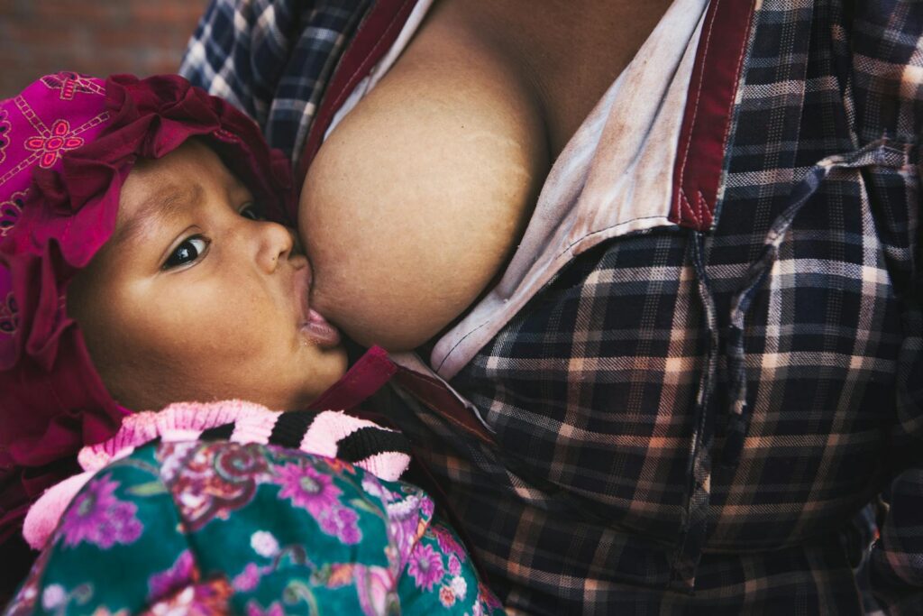 Close Up Photo of Baby Breastfeeding